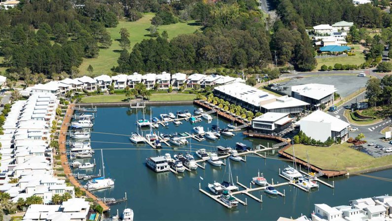 A birds eye view of the Coomera Waters Marina in Queensland featuring Vue 180 Restaurant and HarbourVue Tavern.